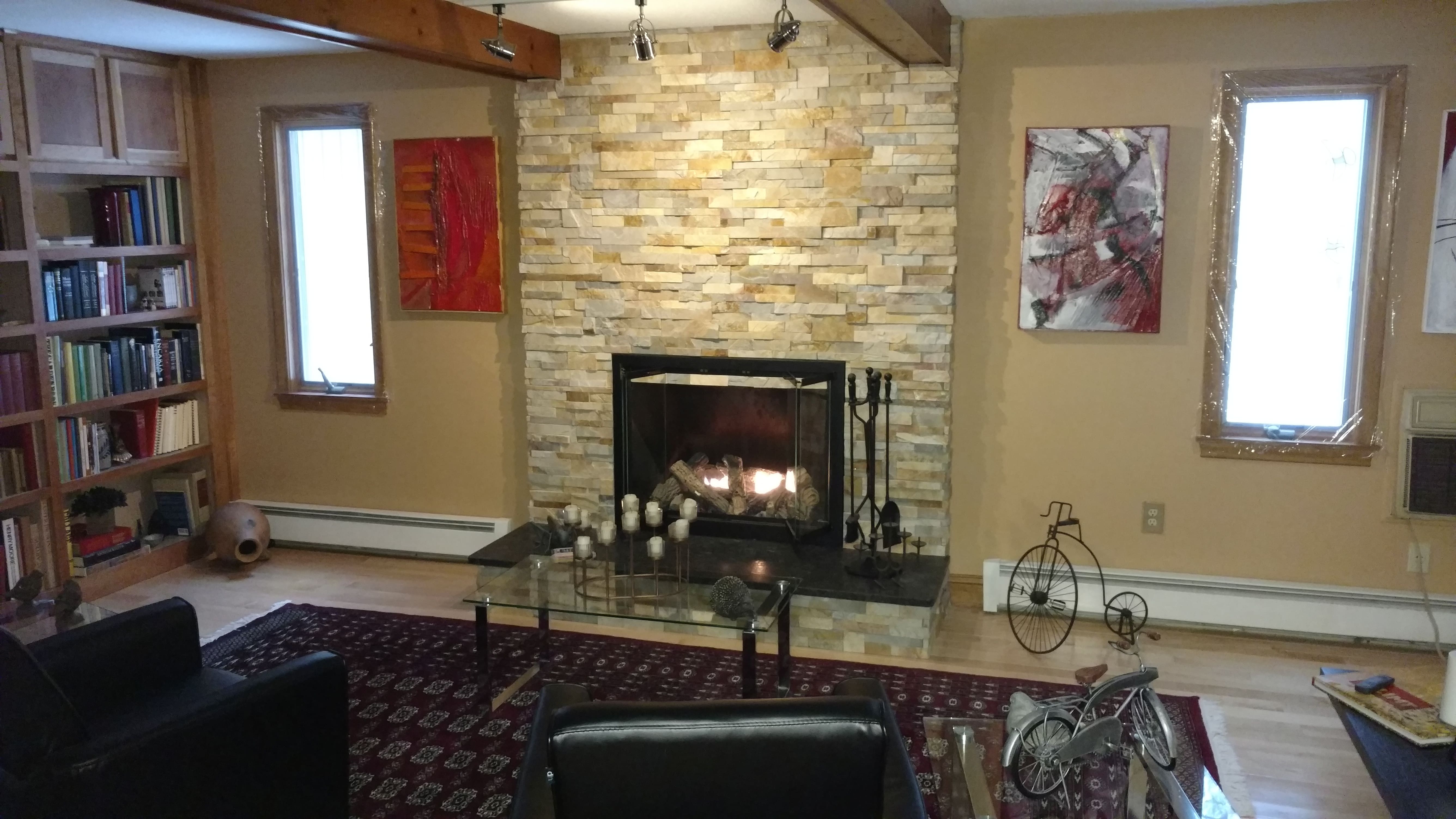 Before and After Project Photos of an old brick fireplace redone using Norstone Aztec XL Stone Veneer
